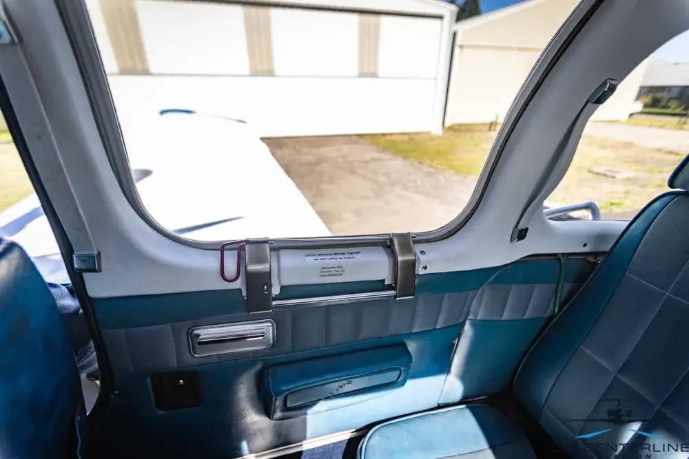 View of the interior door and blue upholstery of the aircraft.
