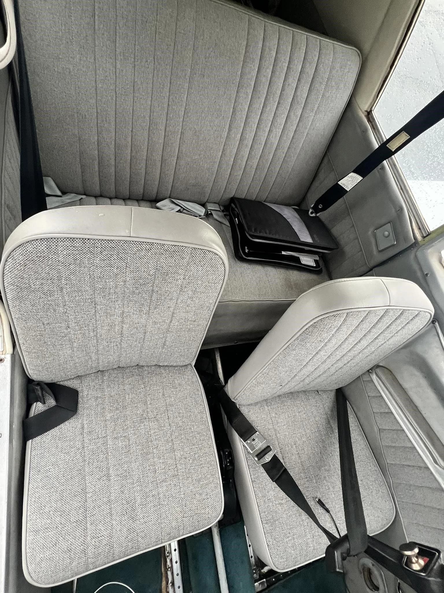 View of the gray fabric seats in the cabin of the Piper Cherokee 235 B.
