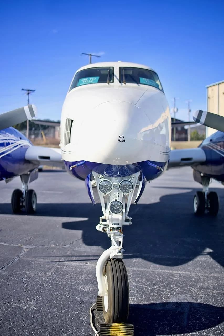 A head-on view of the nose and front landing gear of the N222LP aircraft, showing the cockpit windshield and 'NO PUSH' label.