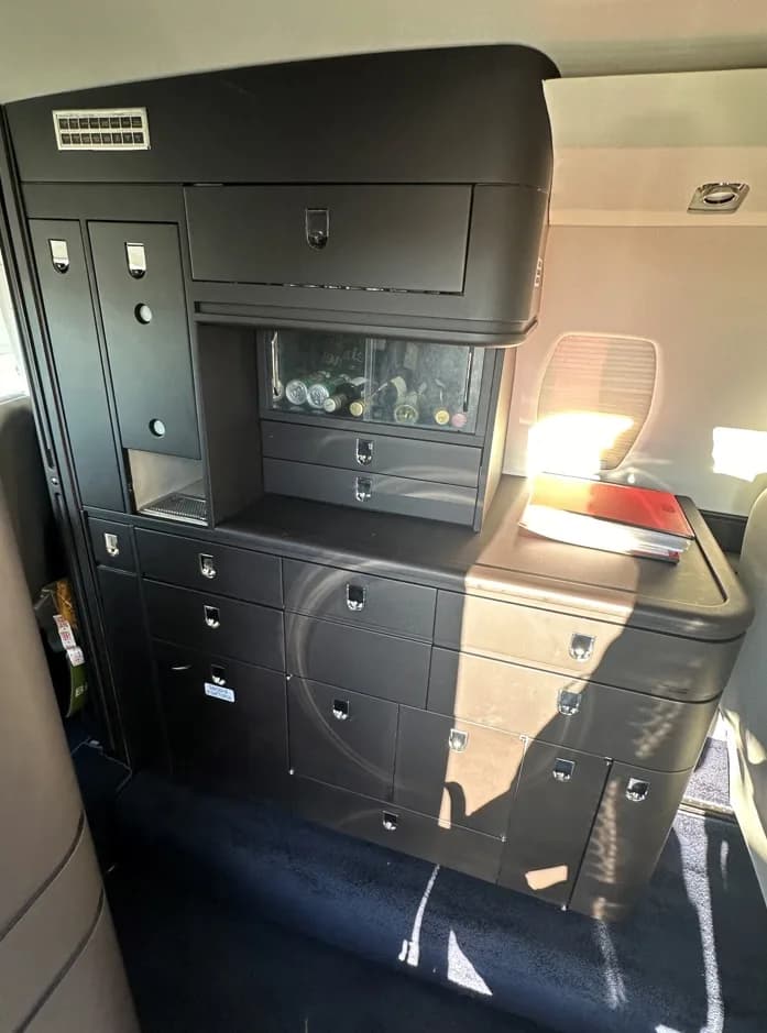 View of the aircraft's interior with a cabinet and drawers.