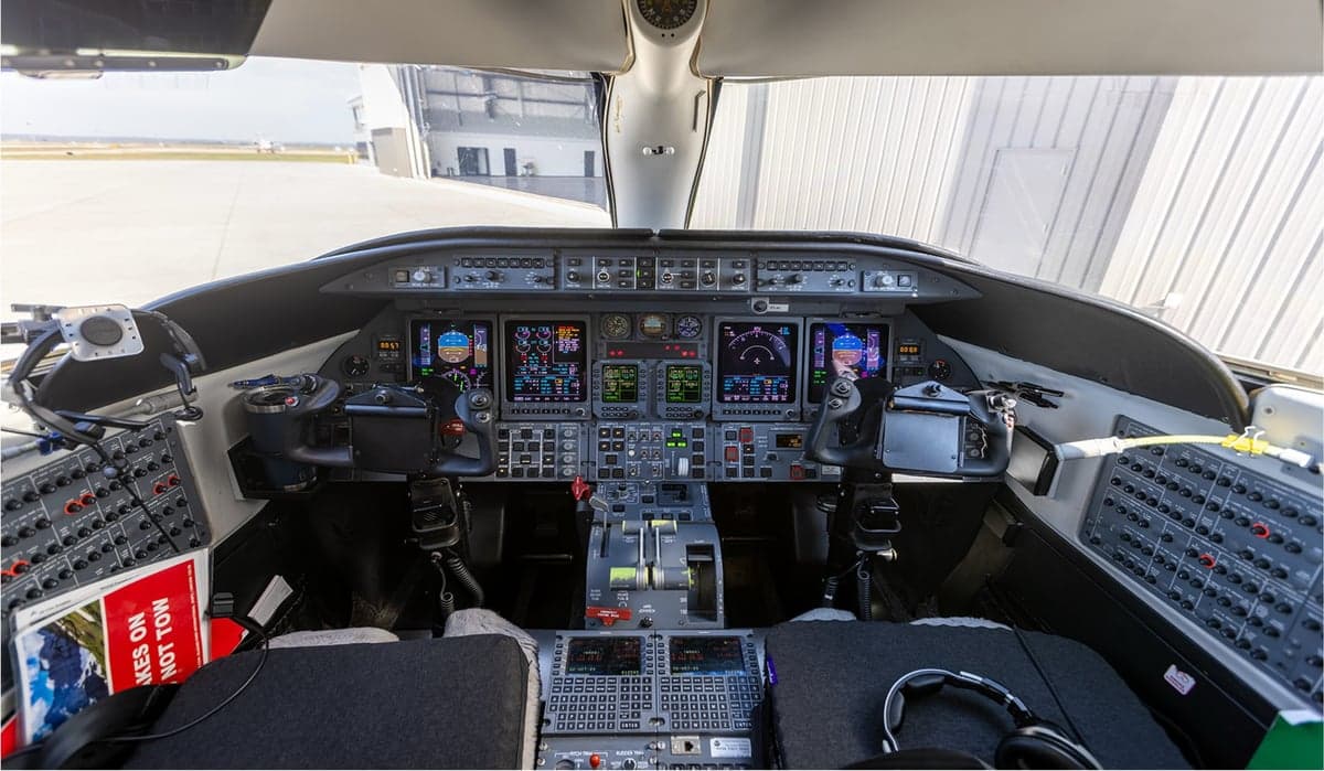 The instrument panel and controls of an aircraft cockpit.