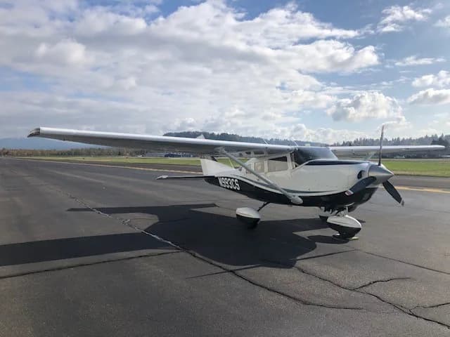 Cessna Stationair N993CS on the runway with a mountain backdrop.