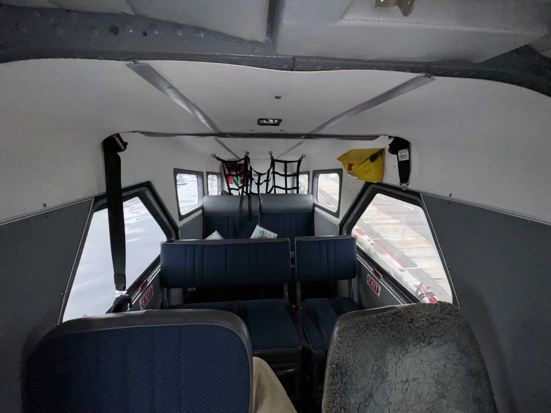 View of the rear passenger seats inside the aircraft cabin.
