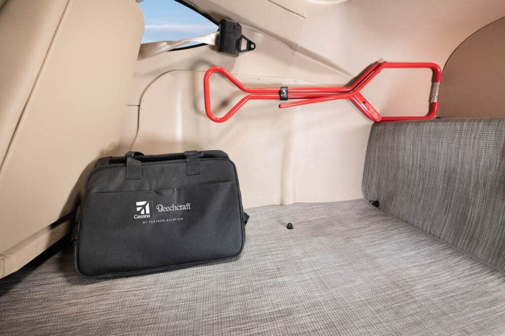 The rear cargo area of a Cessna Skylane with a Beechcraft bag.