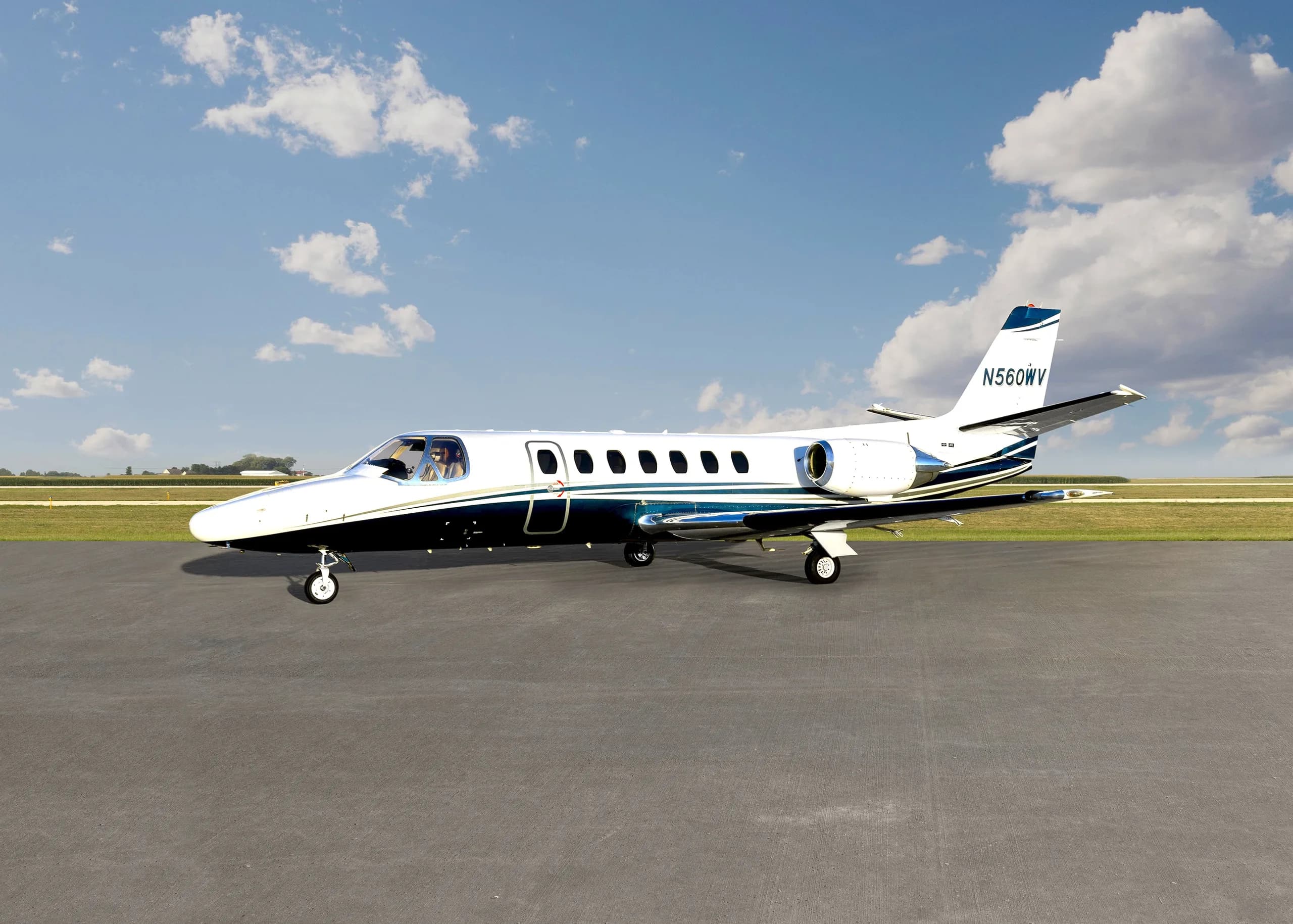 A Cessna Citation CJ1+ aircraft with registration N560WV on the tarmac, side view.