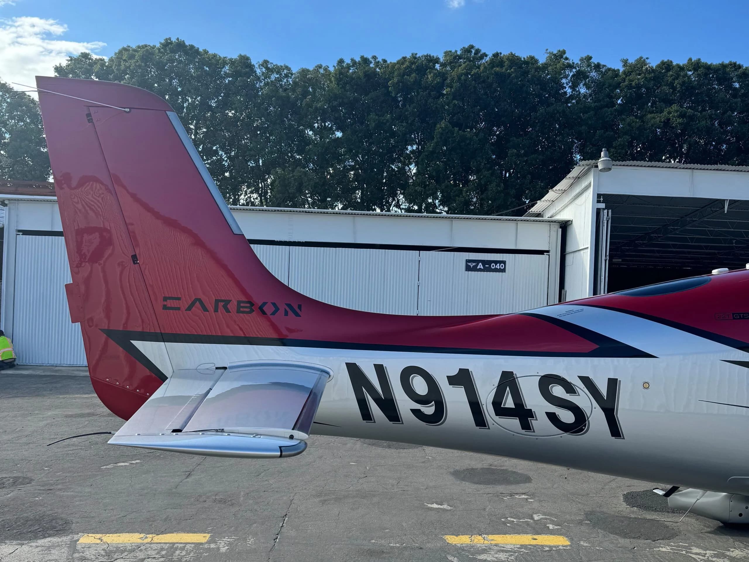 A close-up of the red tail and registration N914SY on the Cirrus SR22 aircraft.