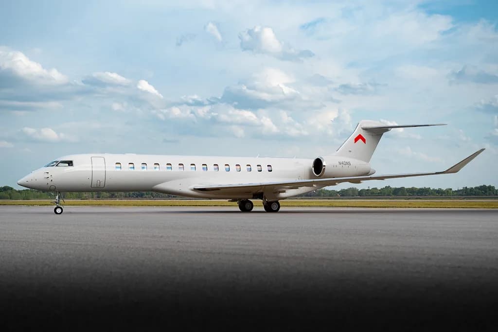 A white Bombardier Global 7500 business jet, tail number N40NS, parked on a tarmac under a cloudy sky.