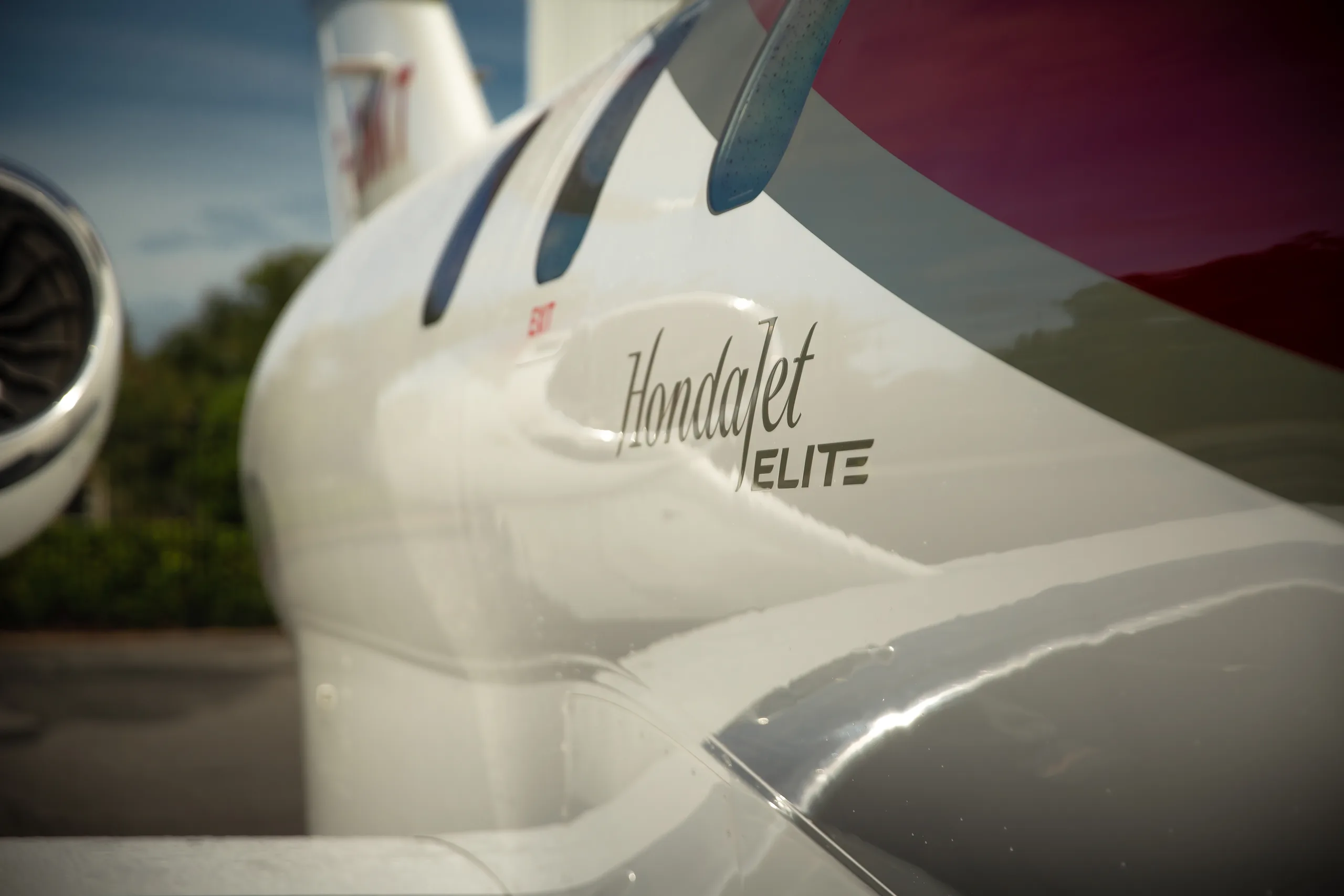 A close-up of the white tail section of a HondaJet ELITE, showing the 'HondaJet ELITE' script.