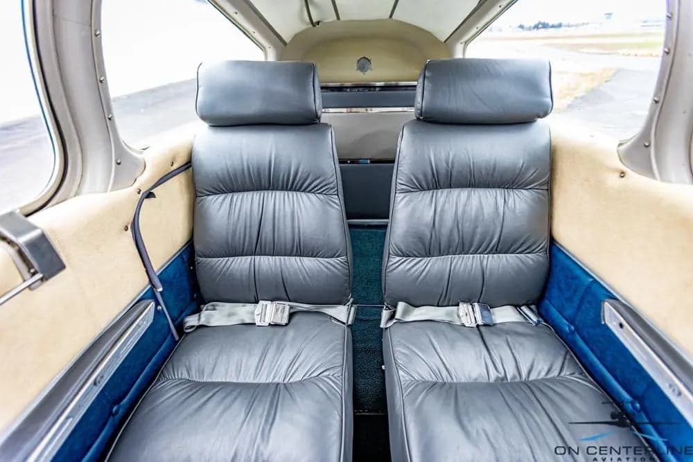 View of the gray leather seats in the cabin of the aircraft.