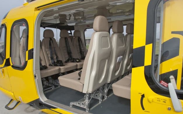 The interior of the yellow helicopter features seating for several passengers.