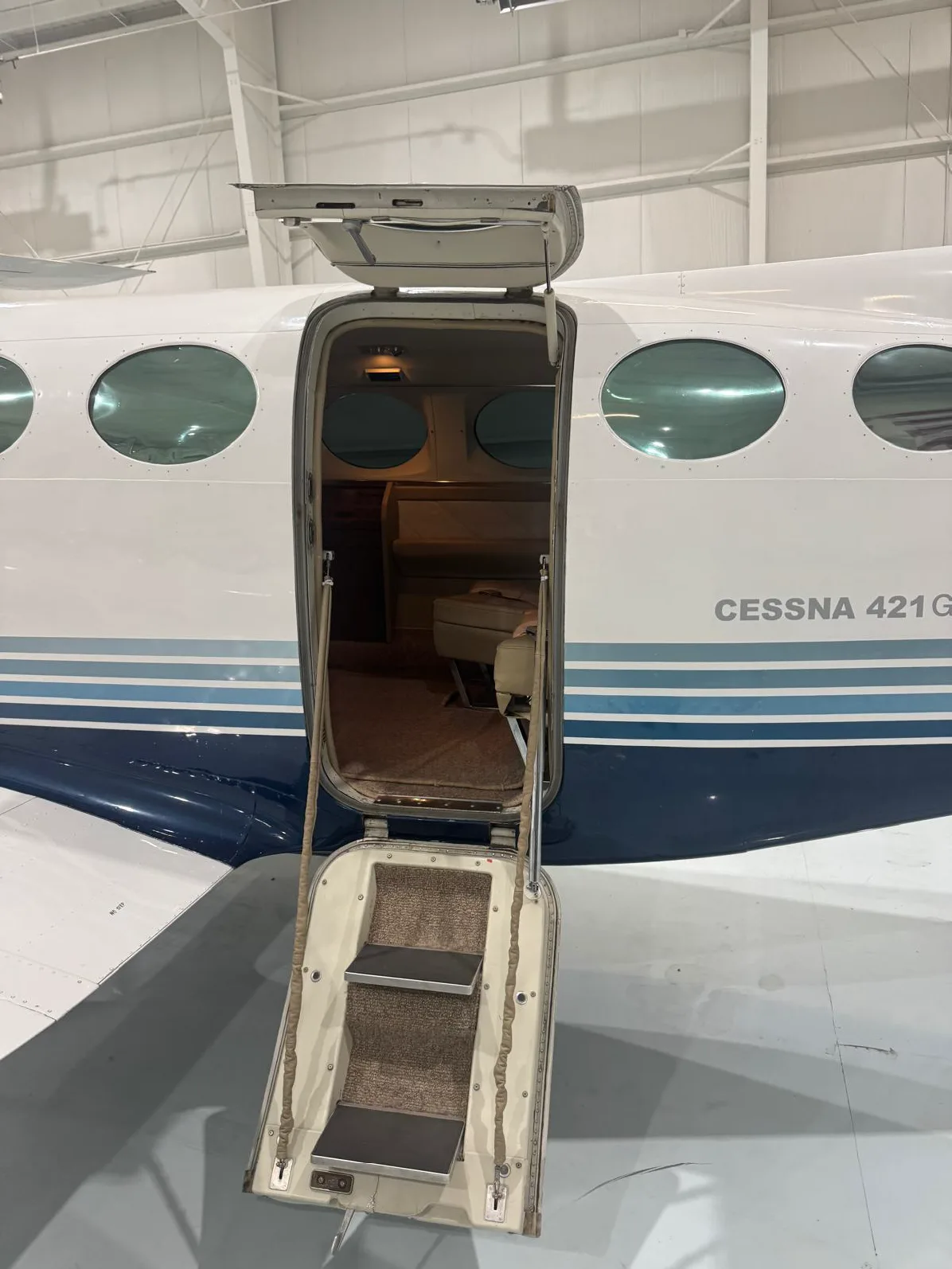 The open door of a Cessna 421 Golden Eagle with the Cessna 421 Golden Eagle logo.