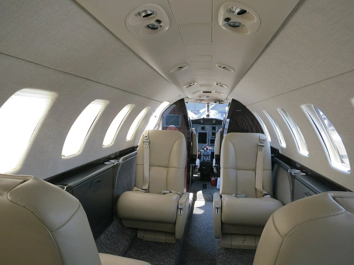 View of the aircraft interior showing forward-facing seats.