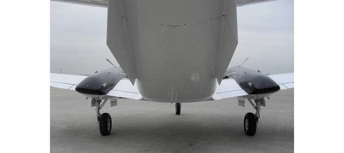 Rear view of a Beechcraft King Air showing the tail and landing gear.