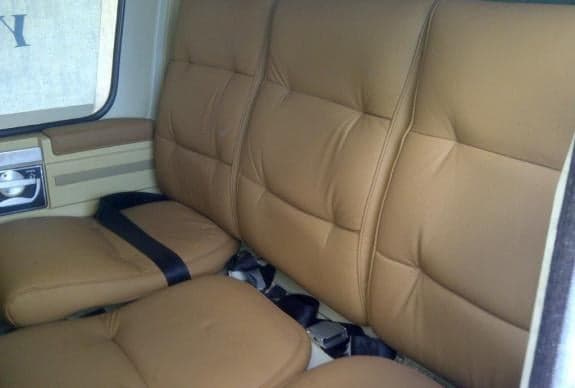 Tan leather seats inside the helicopter cabin.