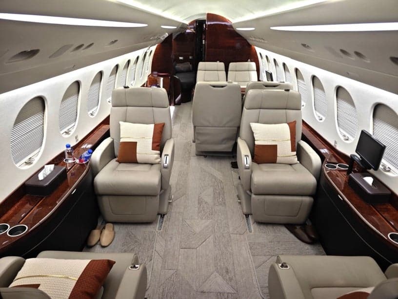 View of the aircraft interior with leather seats and pillows.