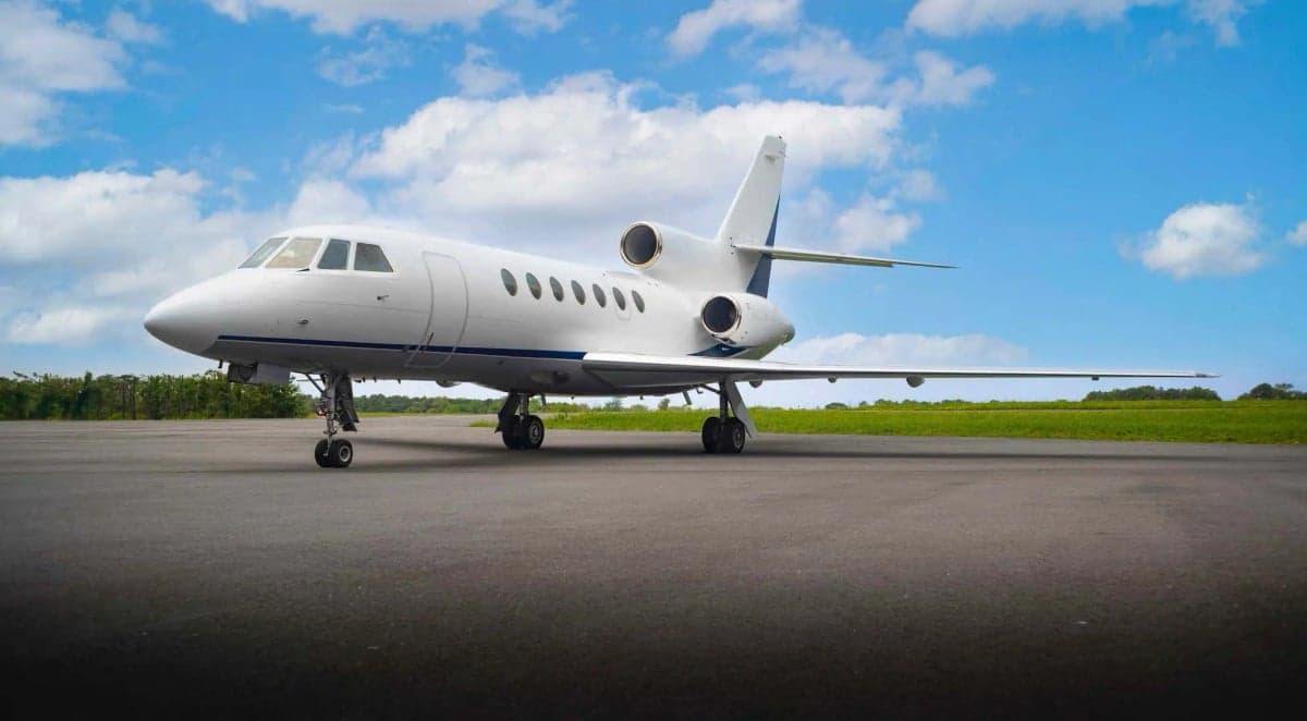 A Falcon jet parked on the tarmac.