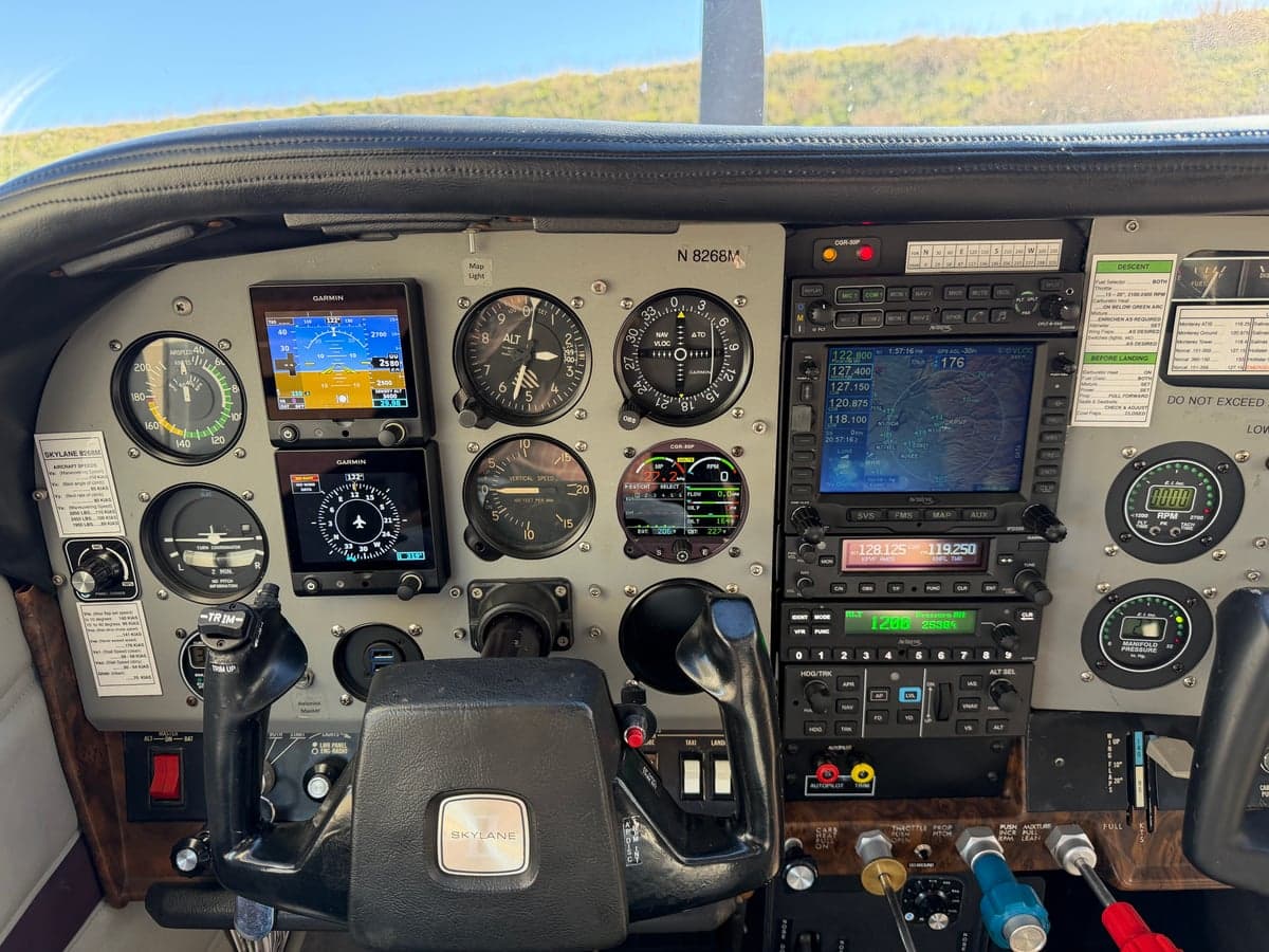 Close-up of the N8268M aircraft's instrument panel, showcasing various gauges and avionics.