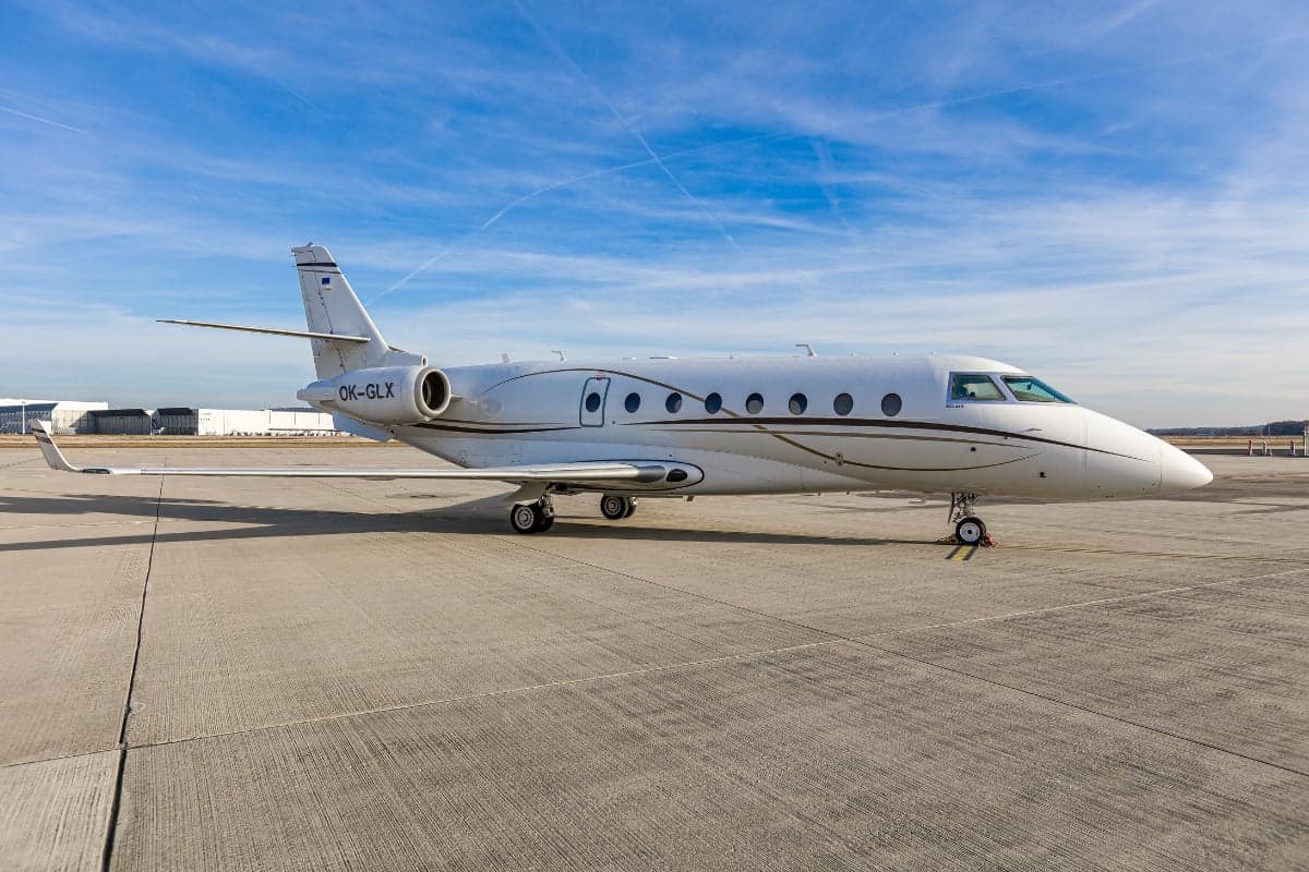 Gulfstream G200 aircraft with the tail number OK-GLX parked on the tarmac.