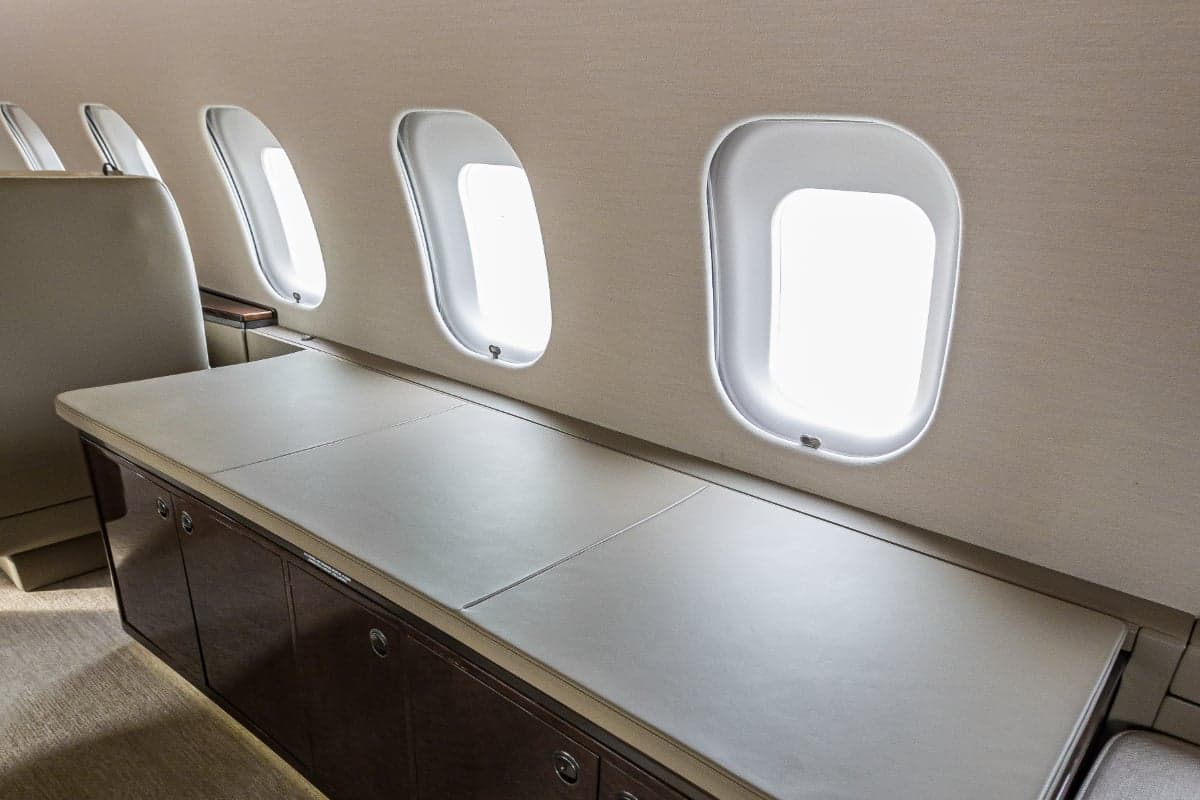 A view of the interior of the aircraft, showing the side console and windows.