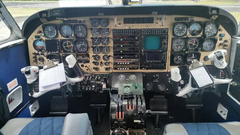 Cockpit instrument panel with various gauges and controls.
