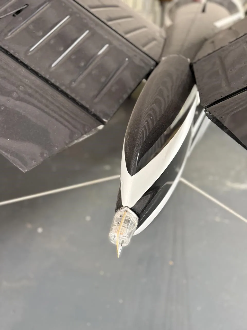 An overhead view of the aircraft's black and white striped tail cone with a clear light at the tip.