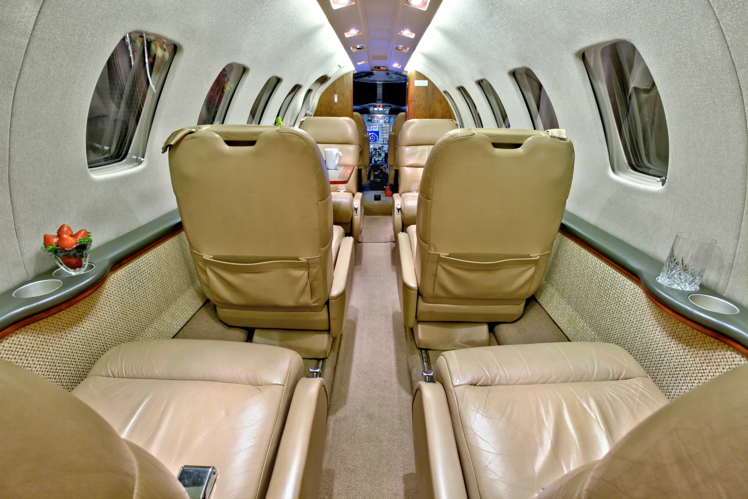 The interior of a Cessna Citation CJ1+ featuring leather seats and a view towards the cockpit.