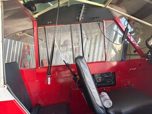 View of the aircraft's cockpit showing the seats and instrument panel.