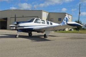 N563AP Bonanza aircraft parked on the tarmac, side view.