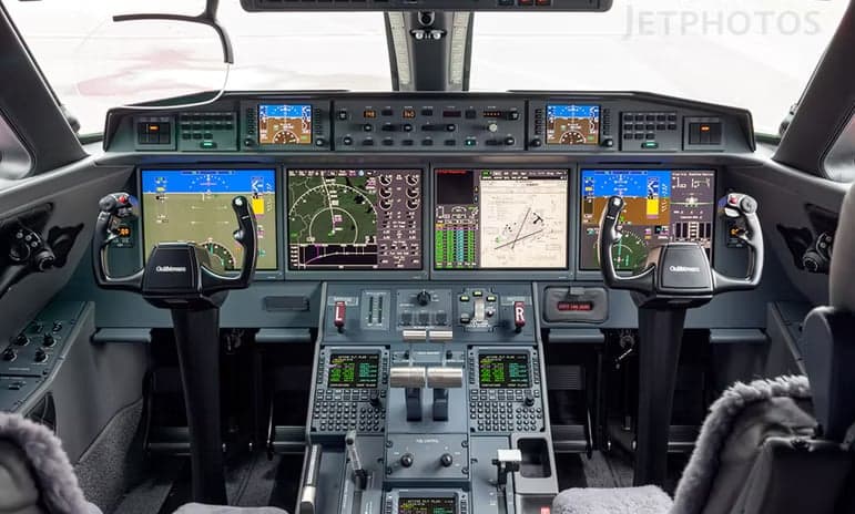 Interior view of a Gulfstream jet with dining setup.