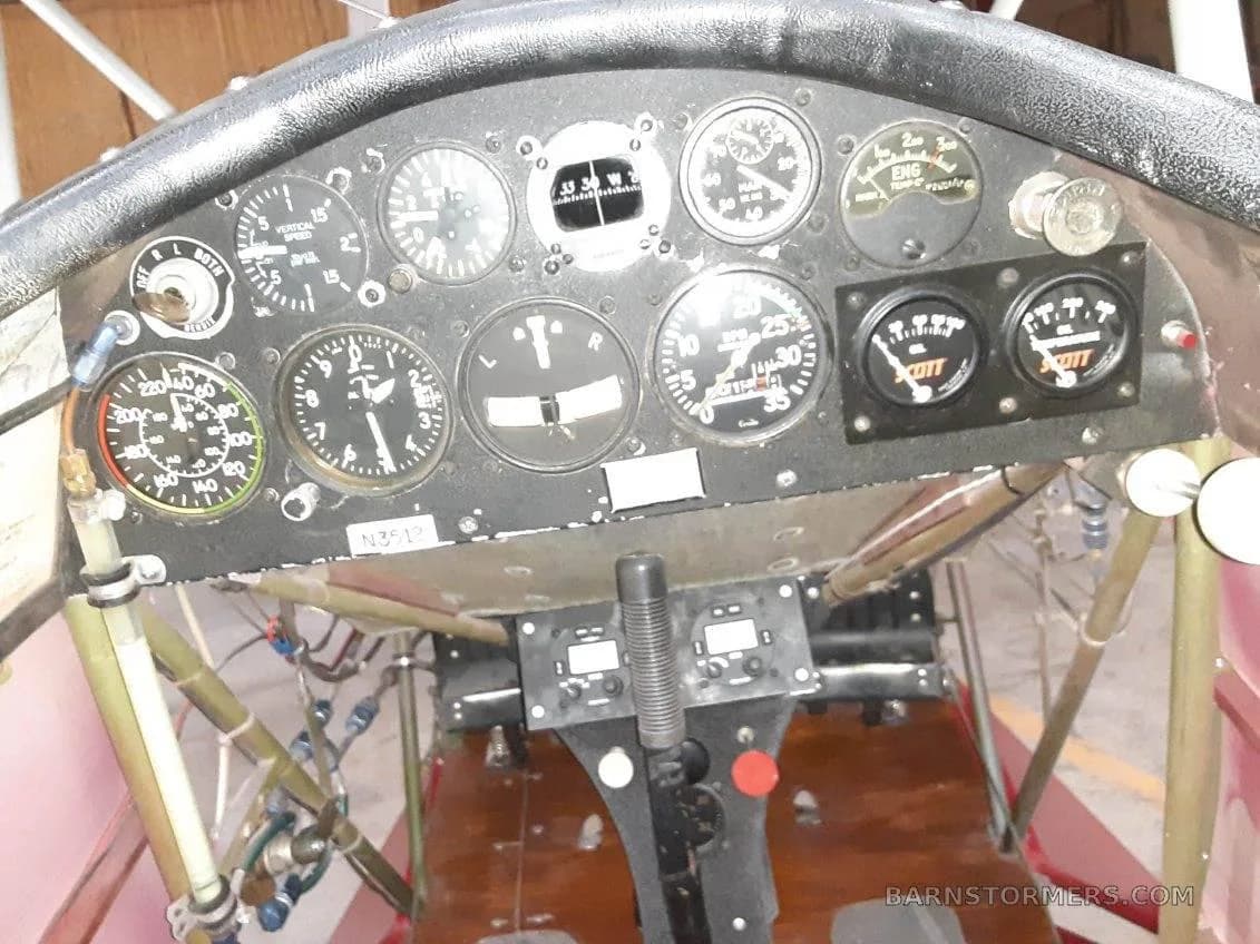 The instrument panel of a biplane, showing various gauges and controls.