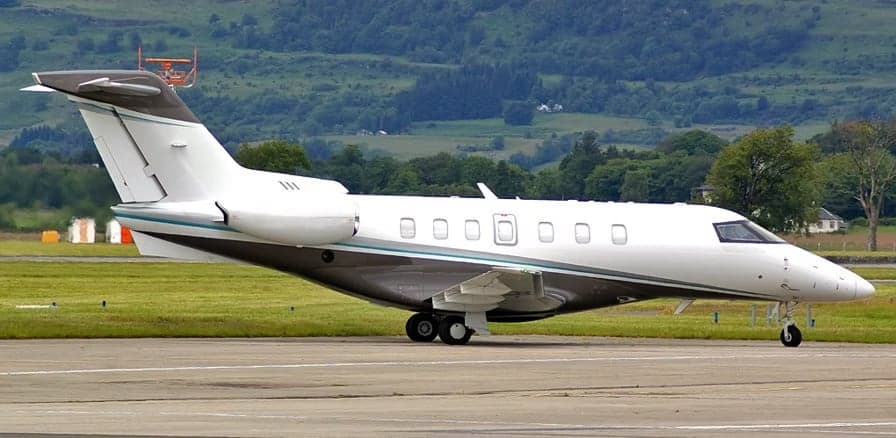 A light jet aircraft parked on the tarmac.