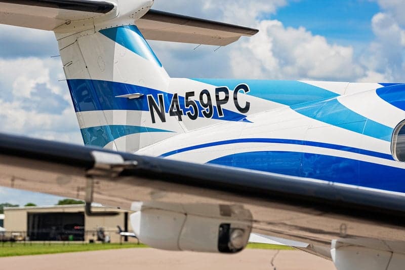 Close-up of the tail of a Pilatus PC-12 aircraft showing the registration number N459PC.