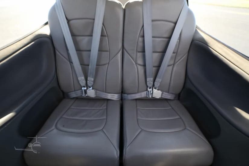 Rear seats of a Cirrus SR22 aircraft, showing the leather upholstery and seatbelts.