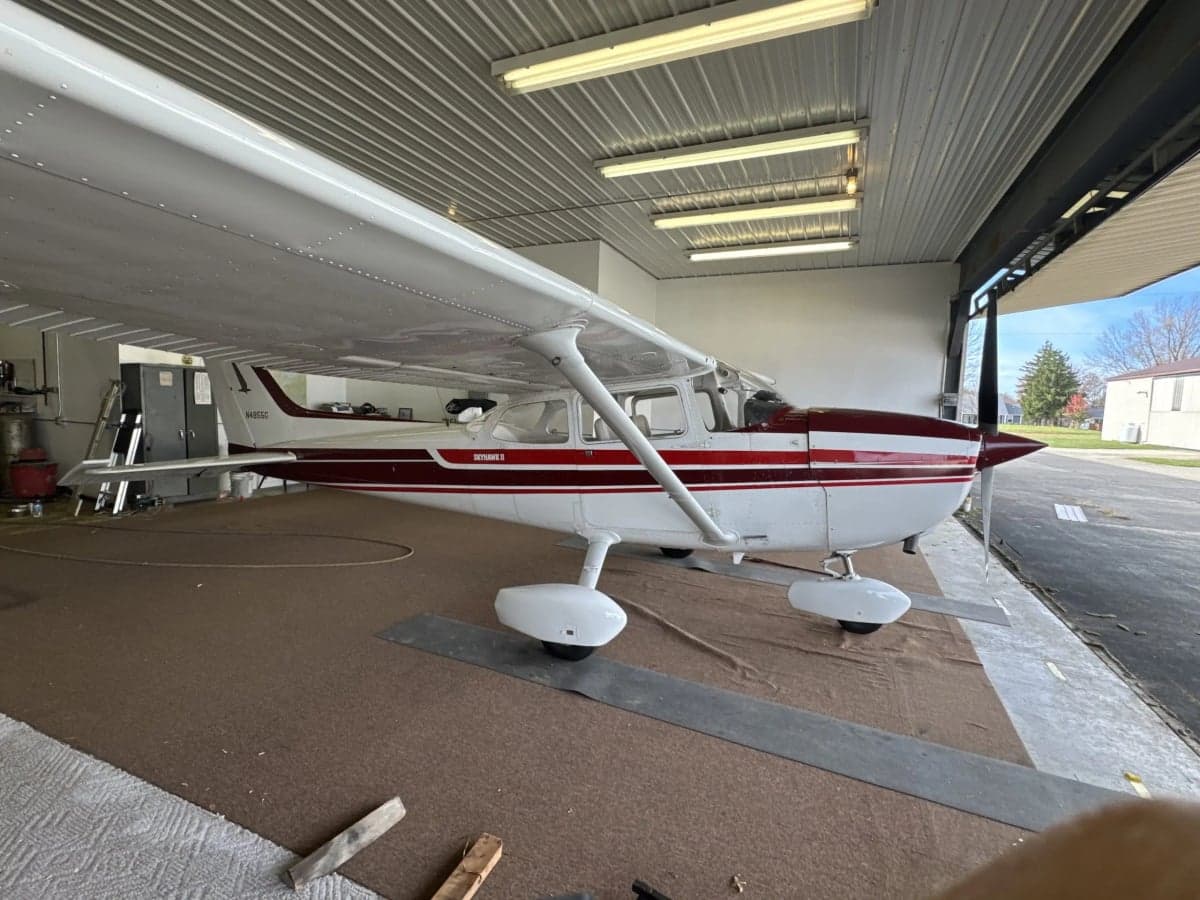 Cessna 172 N4855G in a hangar with white and red paint scheme.