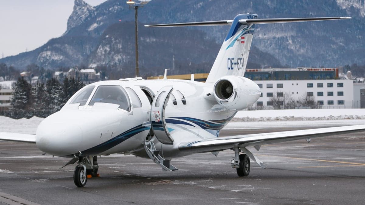 OE-FEA Cessna Citation CJ3 with open door on the tarmac.