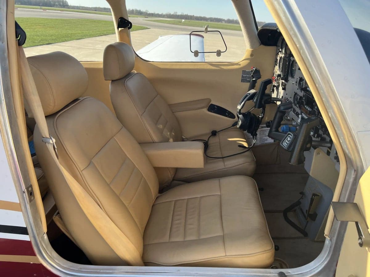 View of the cockpit with tan leather seats and instrument panel.