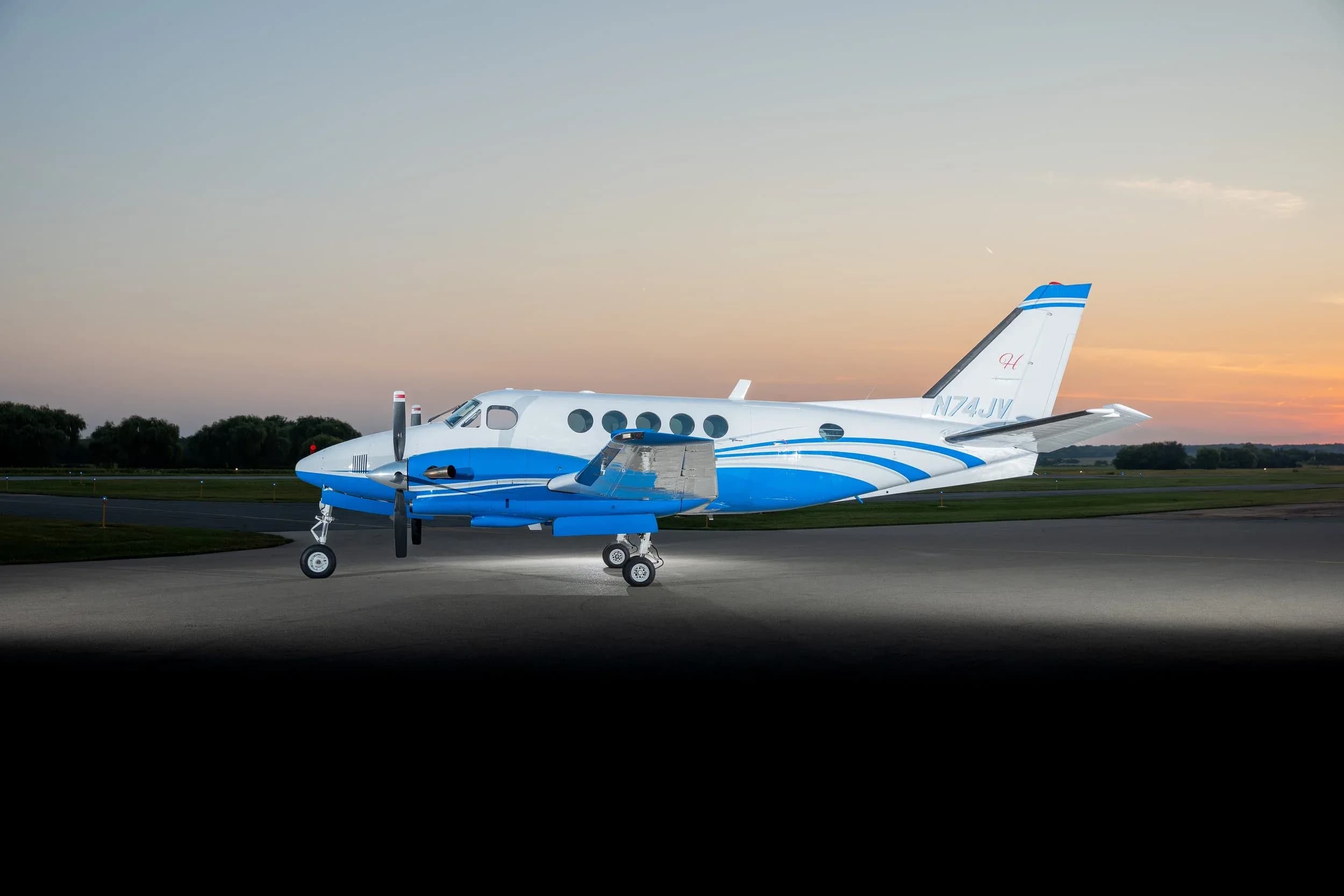 Beechcraft King Air 350i on the tarmac at sunset.