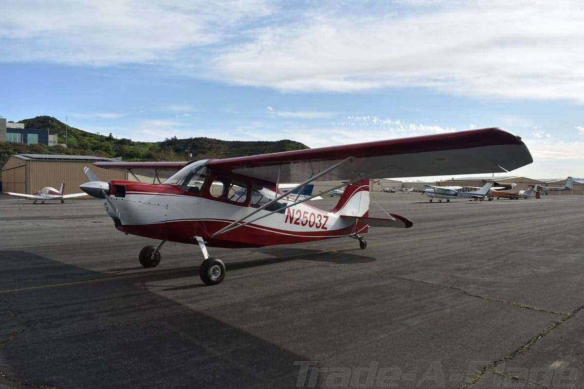 A red and white aircraft with tail number N2503Z is parked on the tarmac.