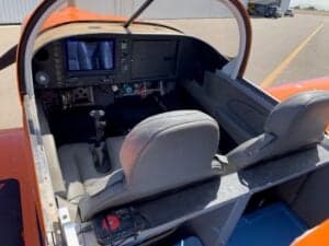 View of the cockpit with instrument panel and seats.