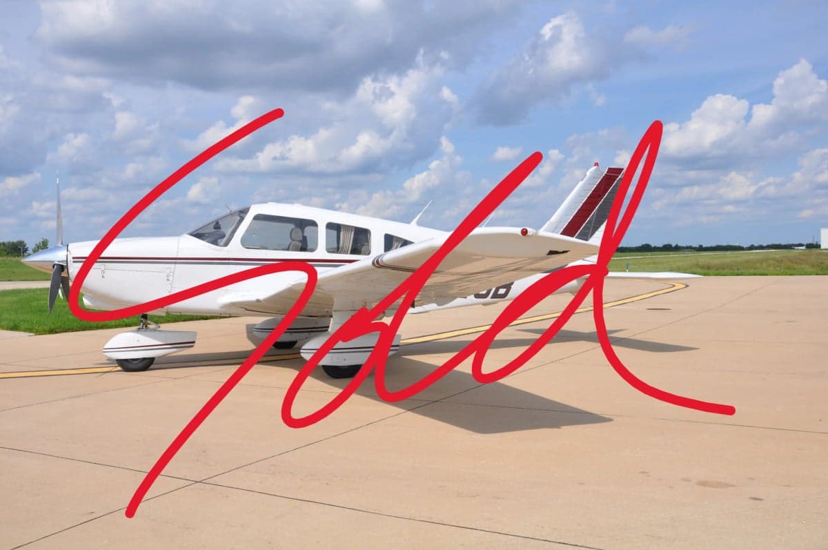A white and maroon Piper PA-28 Cherokee on the tarmac with "SOLD" overlaid.