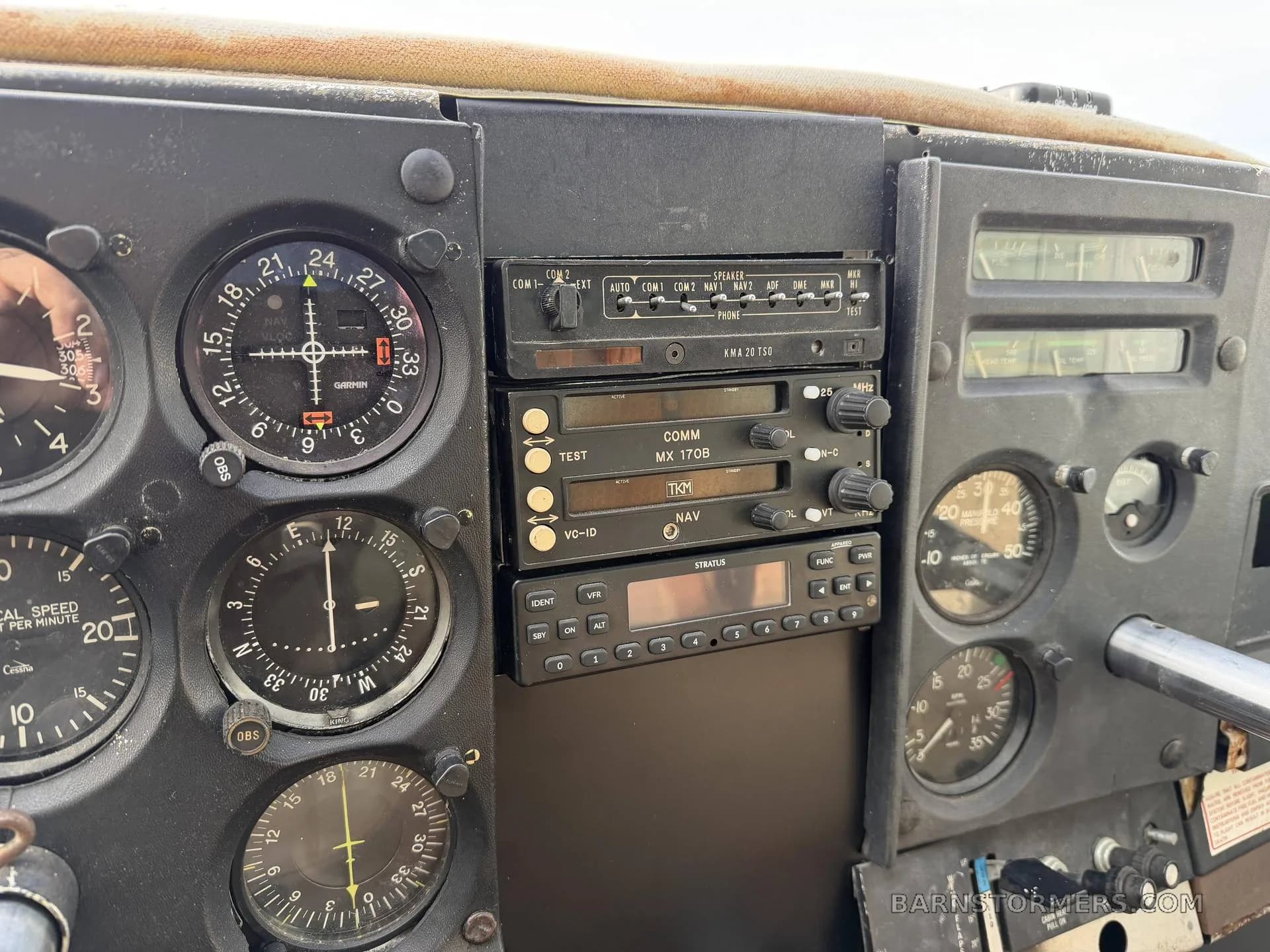 A close-up of an aircraft's avionics stack, featuring communication radios and navigation instruments.