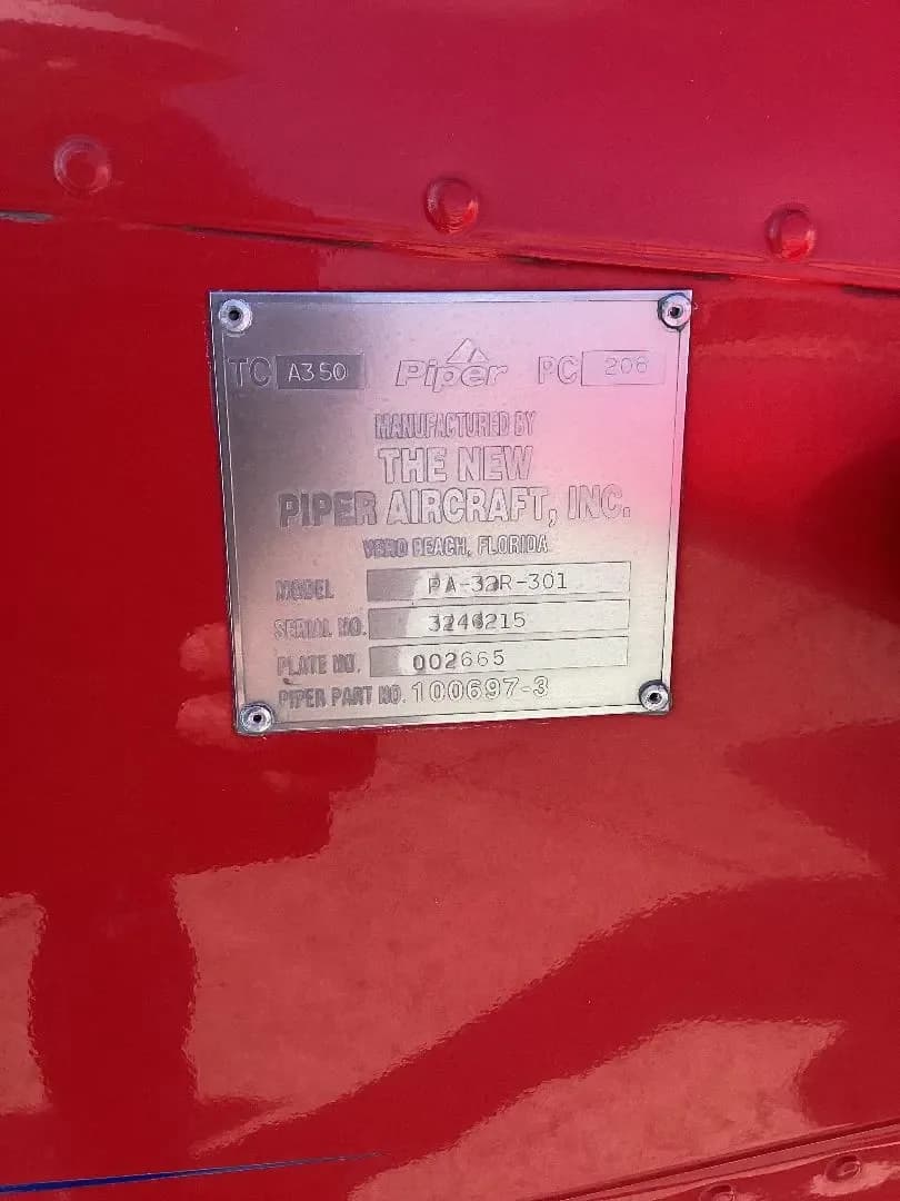 A close-up of the Piper Aircraft manufacturer's data plate for model 19A-32R-301.
