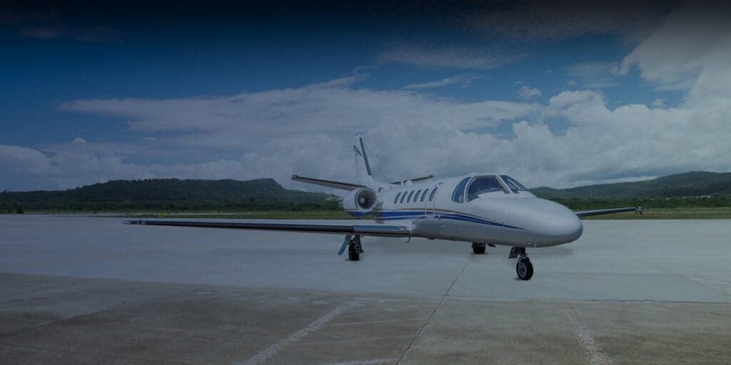 A Falcon aircraft parked on the tarmac with blue accents.