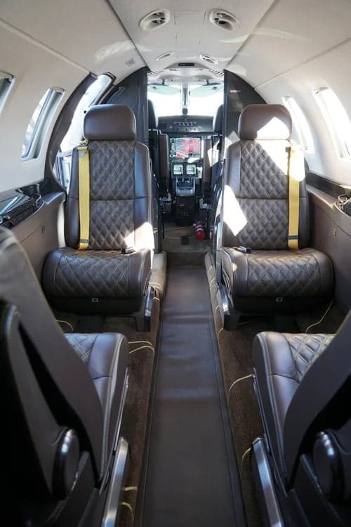 Interior view of the Citation M2 jet cabin with leather seats.