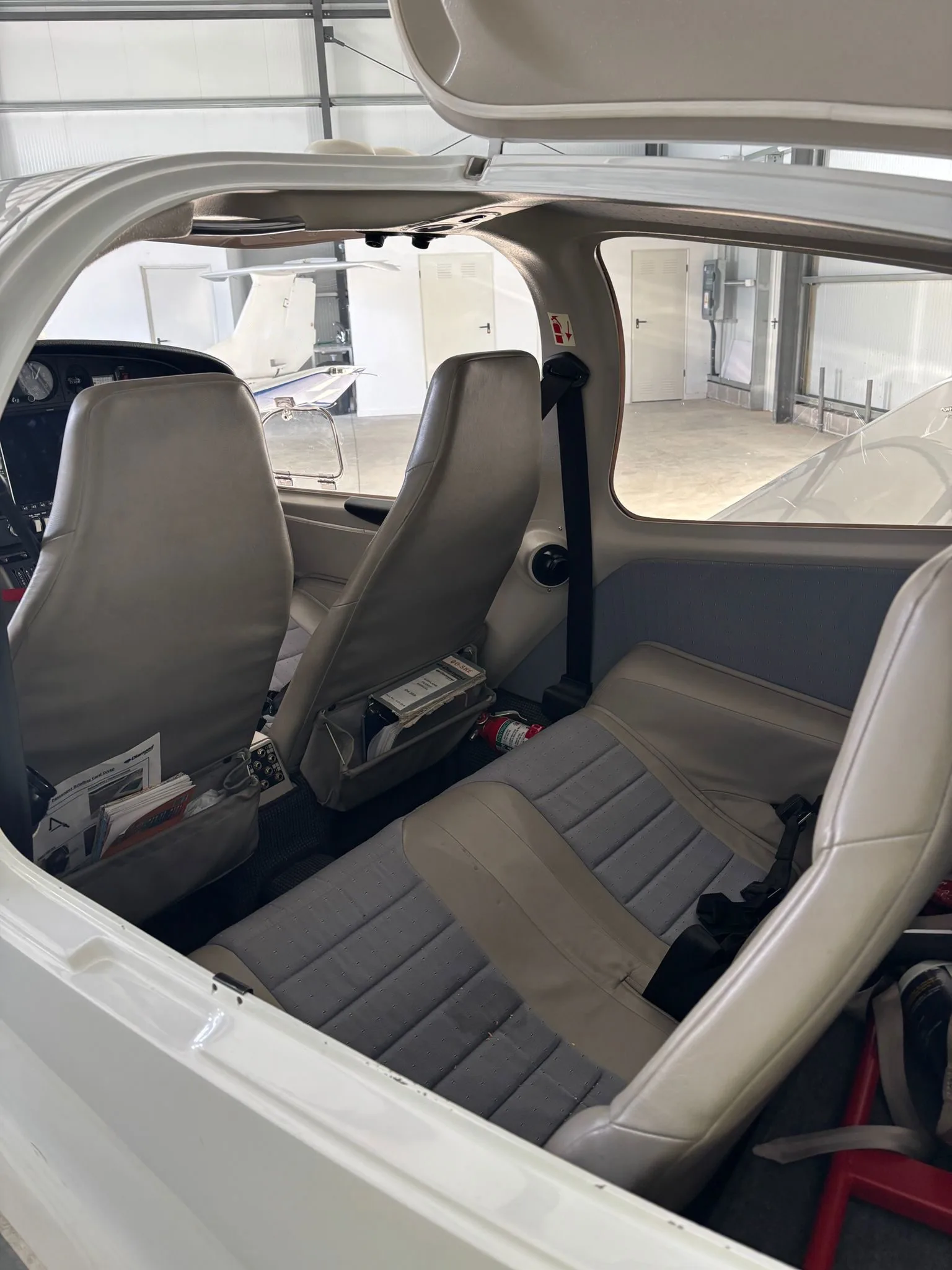 Rear seats of a Diamond DA40 aircraft with gray upholstery.