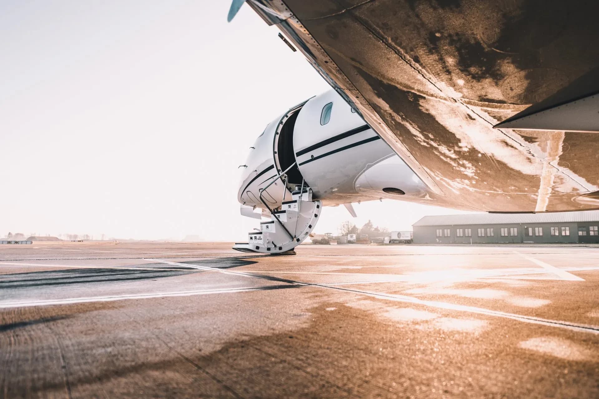 A Challenger aircraft with the door open and stairs extended.