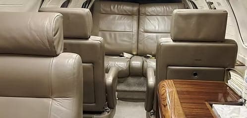 Interior view of the aircraft cabin with leather seats.