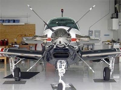 Front view of a Beechcraft Bonanza in a hangar.