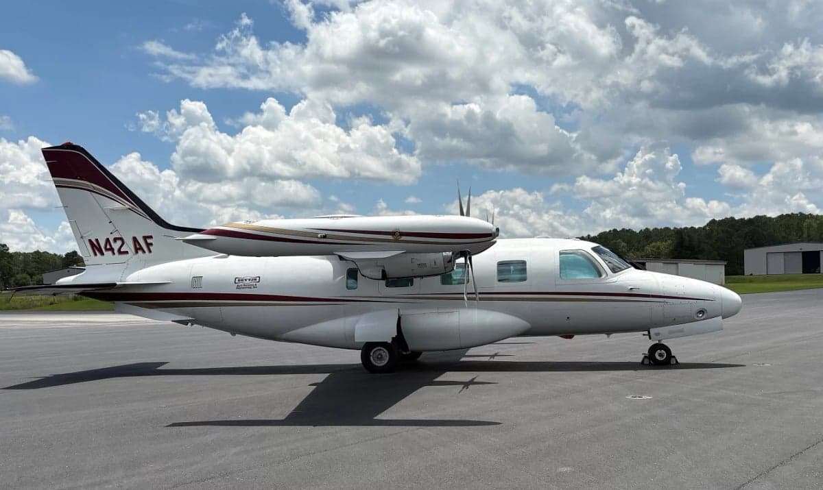 Side view of the aircraft N42AF on the tarmac with the door open.