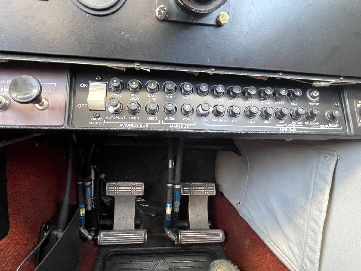 Close-up of the aircraft's avionics bus and rudder pedals.